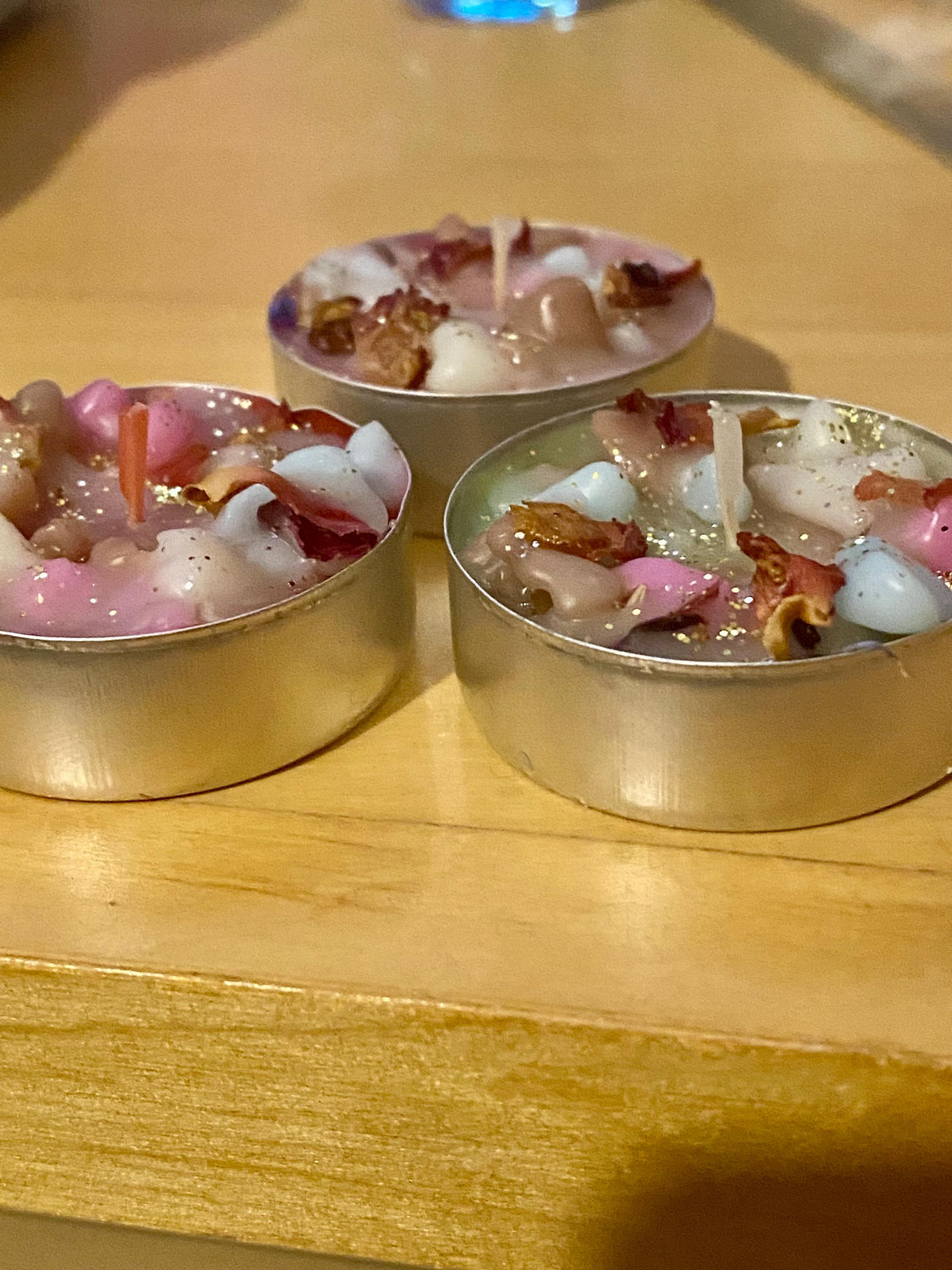 Handmade botanical candles with rose petals and gold sparkle, perfect for gifting, rituals, or cosy home décor.  Various pack sizes.